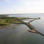 Aerial view towards the Southern embankment of the derelict railway bridge showing the 1867 railway alignment and the present day outer walls of the Oyster beds